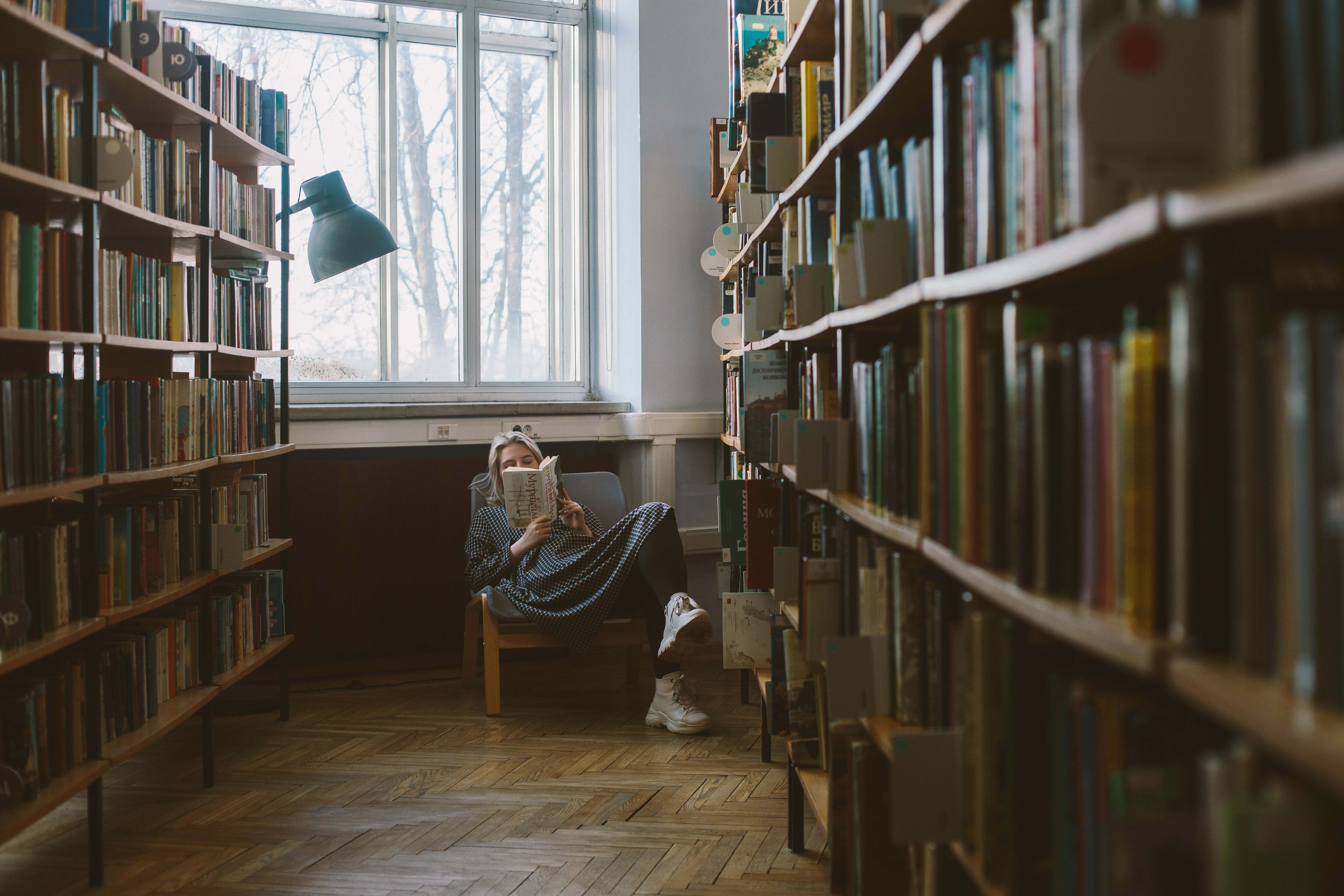 Woman reading book in library